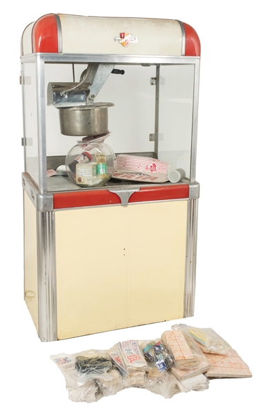 MANLEY MODEL 49 POPCORN MACHINE WITH CONCESSION ITEMS INSIDE AND TWO BOXES OF ACCESSORIES